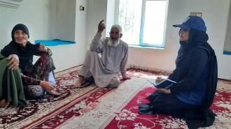a man and a woman sitting on a rug