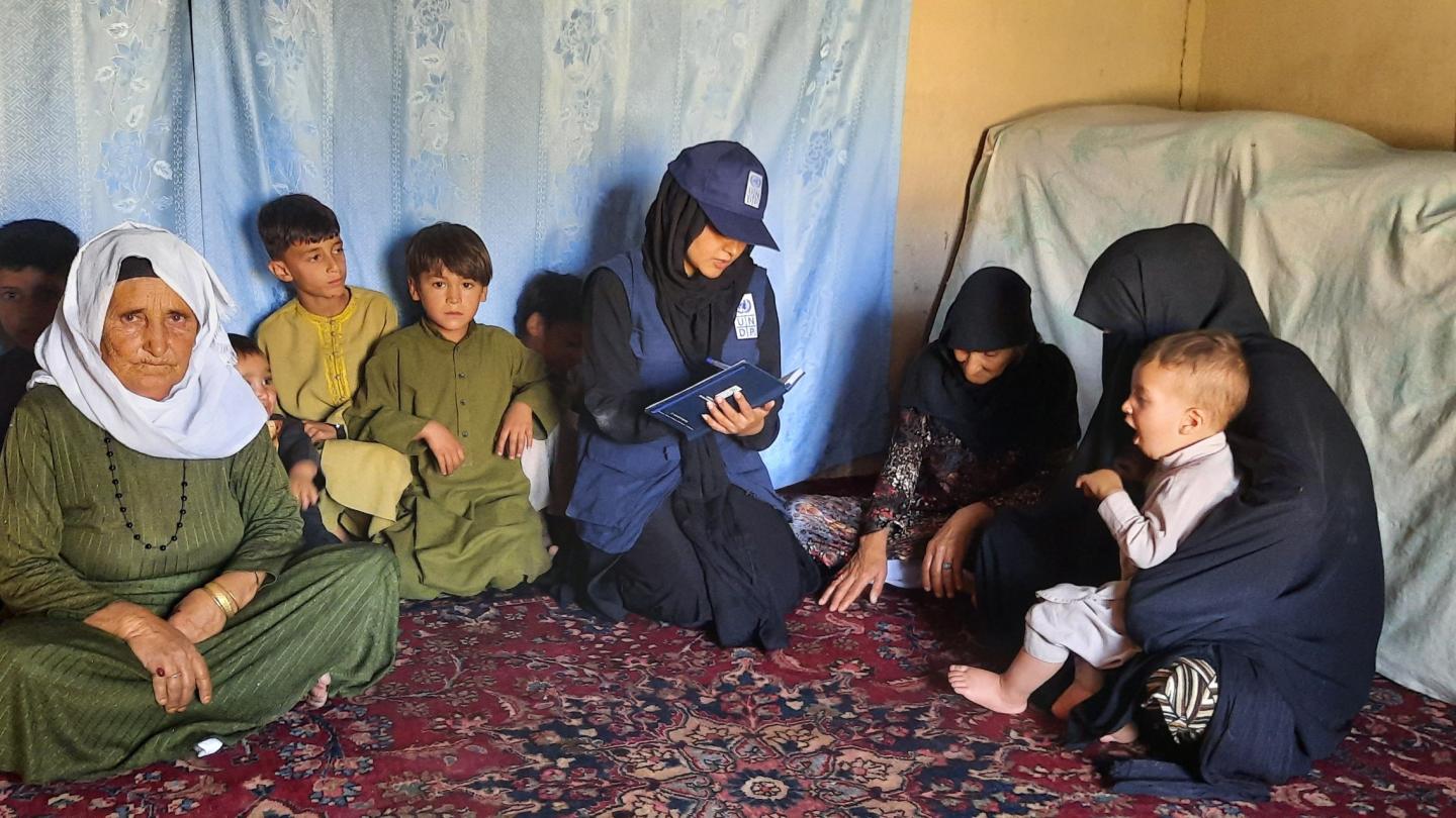 a group of people sitting on a bed