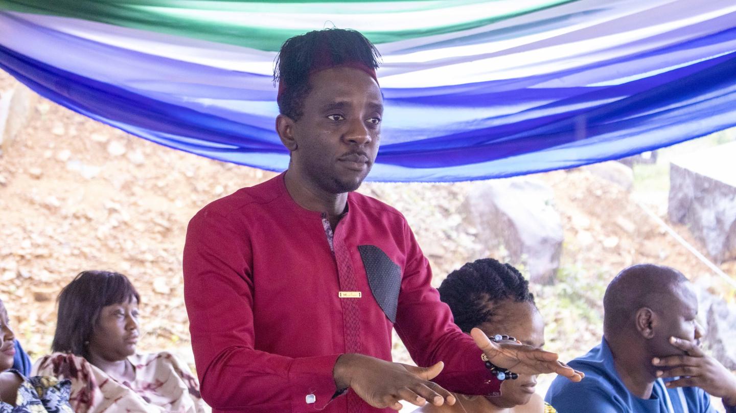 Minister of Education and Civic Education, Chernor Bah a man standing in front of a beach