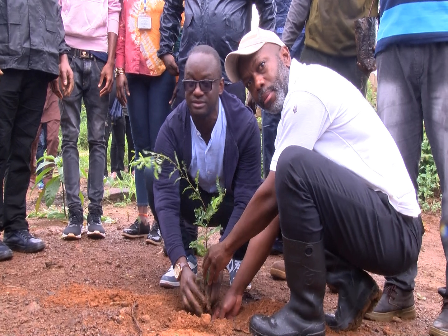 Jiwoh Abdulai, Minister of Environment and Climate Change a group of people standing in front of a crowd
